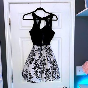 A black and white cocktail dress with a belt